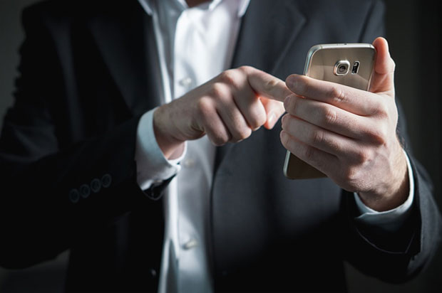 Man in suit using phone