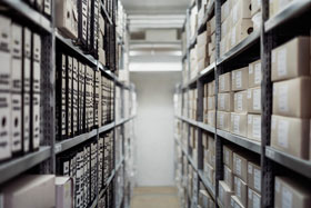 Aisle with Archival Boxes and Folders on Shelves