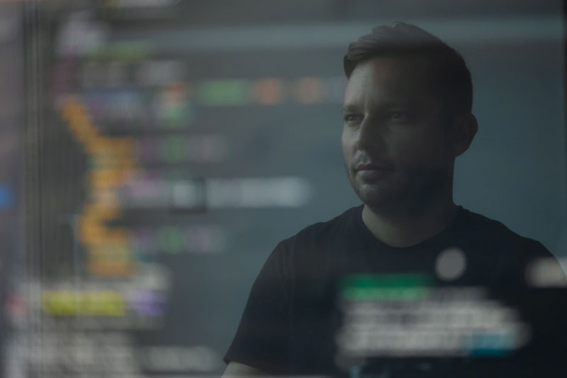 Man in black shirt working on software